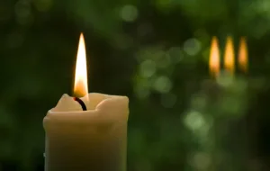 white candle with green background